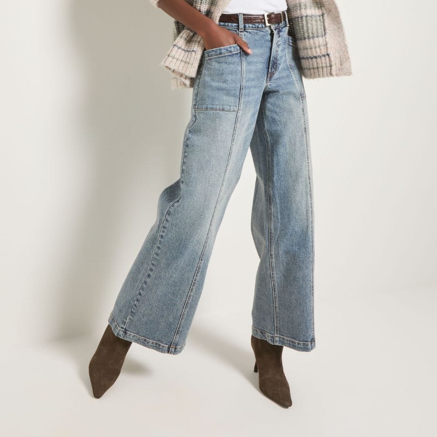 A silhouette shot of a pair of light-wash wide-leg jeans.