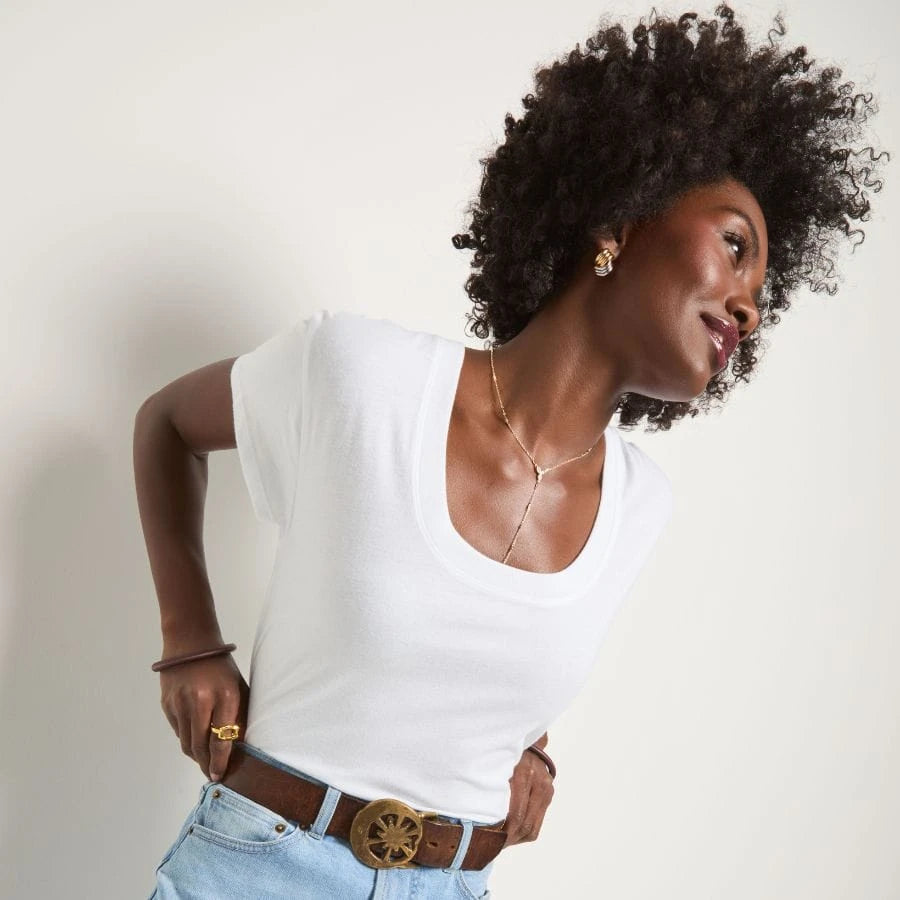 Brunette wearing a relaxed grey t-shirt.