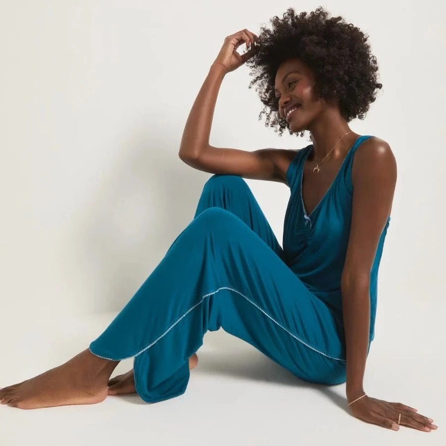 Blonde wearing a lilac pajama set with a spaghetti strap tank top and shorts.